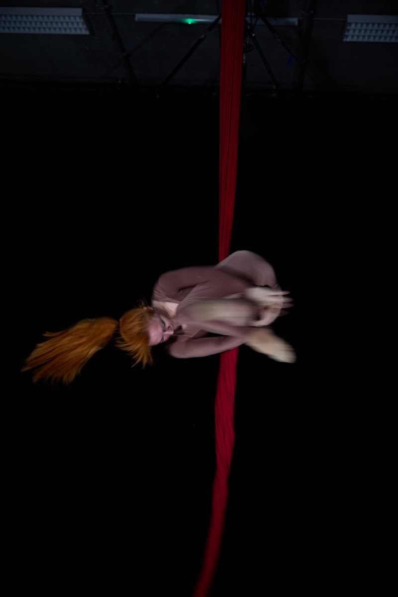 Body folded around a vertical line of red fabric