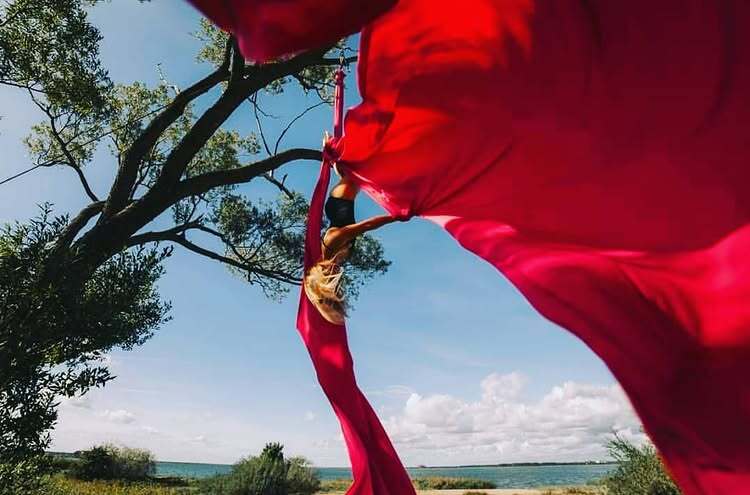 View through moving red fabric towards the lake